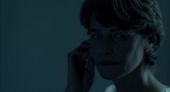 Movie still from “Swimming Pool” (2003), directed by François Ozon – A woman is talking on a cell phone in the dark; Close Up shot, Low angle