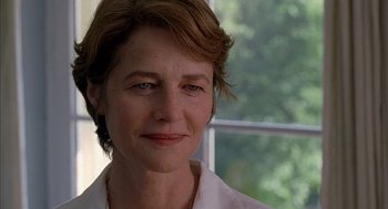 Movie still from “Swimming Pool” (2003), directed by François Ozon – A person wearing a white shirt; Close Up shot, Low angle