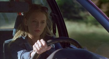 Movie still from “Swimming Pool” (2003), directed by François Ozon – A woman driving a car in the sun; Close Up shot, Low angle