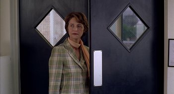 Movie still from “Swimming Pool” (2003), directed by François Ozon – A woman standing in front of an open door; Close Up shot, Over the shoulder angle