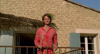 Movie still from “Swimming Pool” (2003), directed by François Ozon – A woman standing on the steps of a building; Medium shot, Low angle