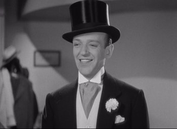 Movie still from “Swing Time” (1936), directed by George Stevens – A man wearing a top hat and a suit; Medium shot, Low angle