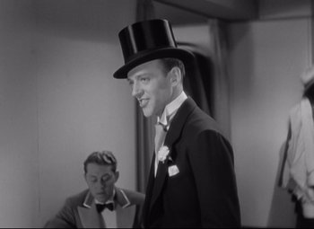 Movie still from “Swing Time” (1936), directed by George Stevens – A man wearing a top hat and a suit; Medium shot, Low angle