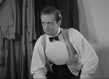 Movie still from “Swing Time” (1936), directed by George Stevens – A black and white photo of a man in a bow tie; Medium shot, Low angle