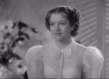 Movie still from “Swing Time” (1936), directed by George Stevens – A black and white photo of a woman in a white dress; Close Up shot, Low angle