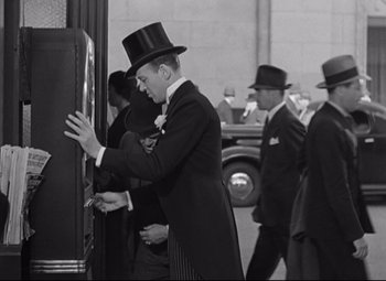 Movie still from “Swing Time” (1936), directed by George Stevens – A black and white photo of a man wearing a top hat; Medium shot, Low angle