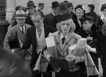 Movie still from “Swing Time” (1936), directed by George Stevens – A group of men and women in hats and ties; Medium shot, High angle