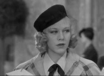 Movie still from “Swing Time” (1936), directed by George Stevens – A black and white photo of a woman wearing a hat; Close Up shot, Over the shoulder angle