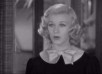Movie still from “Swing Time” (1936), directed by George Stevens – A black and white photo of a woman with blonde hair; Close Up shot, Over the shoulder angle