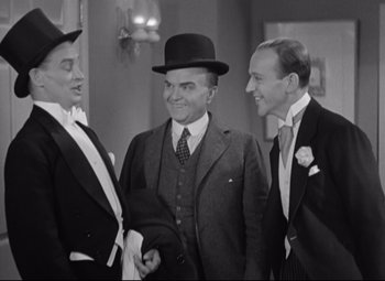 Movie still from “Swing Time” (1936), directed by George Stevens – A group of men standing next to each other in a room; Medium shot, Low angle