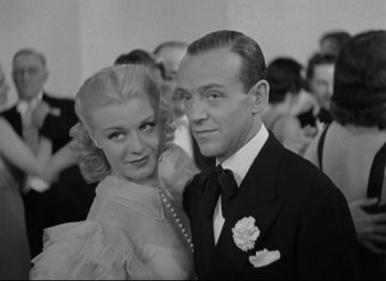 Movie still from “Swing Time” (1936), directed by George Stevens – A man and a woman posing for a picture; Close Up shot, Low angle