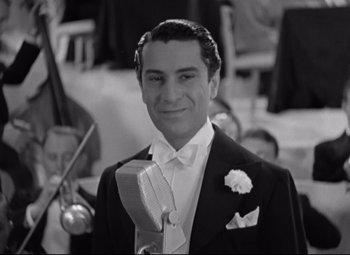 Movie still from “Swing Time” (1936), directed by George Stevens – A man in a tuxedo is smiling for the camera; Close Up shot, High angle