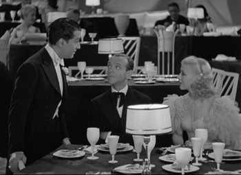 Movie still from “Swing Time” (1936), directed by George Stevens – A group of people sitting around a table; Medium shot, High angle