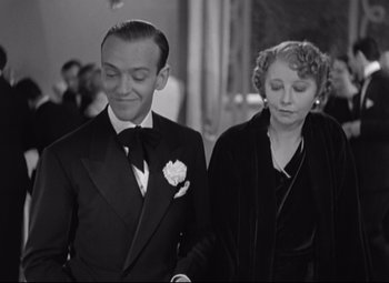 Movie still from “Swing Time” (1936), directed by George Stevens – A man and a woman walking down a hallway; Medium shot, High angle