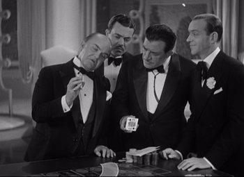 Movie still from “Swing Time” (1936), directed by George Stevens – A group of men in tuxedos standing next to each other; Medium shot, High angle