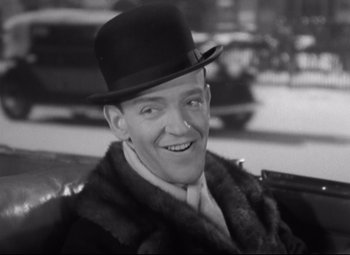 Movie still from “Swing Time” (1936), directed by George Stevens – A man wearing a top hat and a fur coat; Close Up shot, High angle