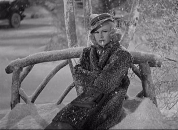 Movie still from “Swing Time” (1936), directed by George Stevens – A woman sitting on a bench in the snow; Medium shot, High angle