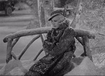 Movie still from “Swing Time” (1936), directed by George Stevens – A woman sitting on a bench in the snow; Medium shot, High angle