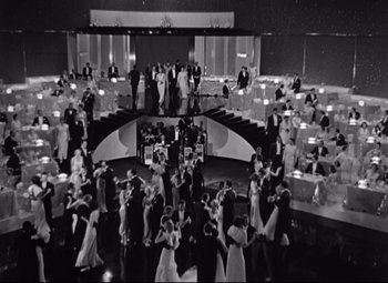 Movie still from “Swing Time” (1936), directed by George Stevens – A black and white photo of people dancing at a party; Extreme Wide shot, High angle