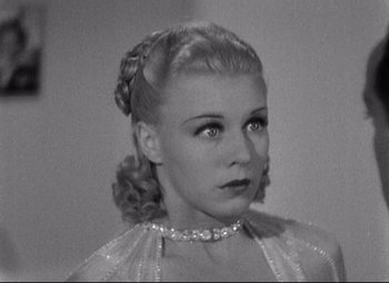 Movie still from “Swing Time” (1936), directed by George Stevens – A black and white photo of a woman in a dress; Close Up shot, High angle