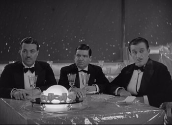 Movie still from “Swing Time” (1936), directed by George Stevens – A group of men sitting at a table holding wine goblets; Medium shot, High angle