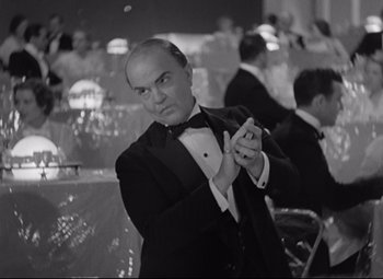 Movie still from “Swing Time” (1936), directed by George Stevens – A black and white photo of a man in a tuxedo; Medium shot, Low angle