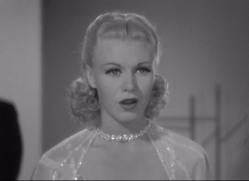 Movie still from “Swing Time” (1936), directed by George Stevens – A black - and - white photo of a woman in a white dress; Close Up shot, Low angle