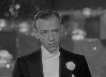 Movie still from “Swing Time” (1936), directed by George Stevens – A man in a tuxedo with a white flower in his lapel; Close Up shot, High angle