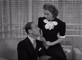 Movie still from “Swing Time” (1936), directed by George Stevens – A man and a woman are sitting on a bench; Medium shot, High angle