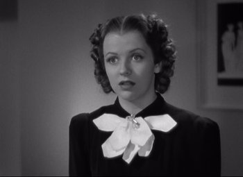 Movie still from “Swing Time” (1936), directed by George Stevens – A black and white photo of a woman with a bow tie around her neck; Close Up shot, Low angle