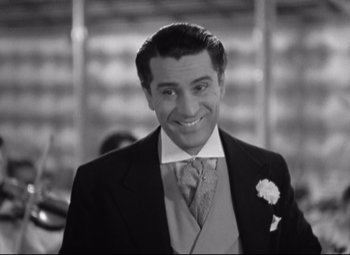 Movie still from “Swing Time” (1936), directed by George Stevens – A black and white photo of a man in a suit; Close Up shot, High angle
