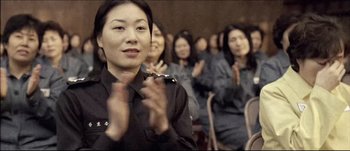 Movie still from “Sympathy for Lady Vengeance” (2005) – A group of women clapping in a conference room; Close Up shot, High angle
