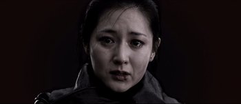 Movie still from “Sympathy for Lady Vengeance” (2005) – A person wearing a black jacket; Close Up shot, Low angle