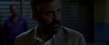 Movie still from “Syriana” (2005), directed by Stephen Gaghan – A person with a beard; Close Up shot, Over the shoulder angle