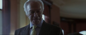 Movie still from “Syriana” (2005), directed by Stephen Gaghan – An older man wearing a suit and a tie; Close Up shot, Low angle
