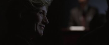 Movie still from “Syriana” (2005), directed by Stephen Gaghan – A woman's face in the dark; Close Up shot, Over the shoulder angle