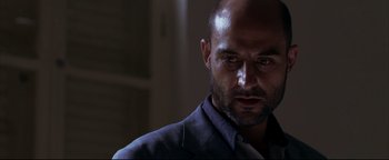 Movie still from “Syriana” (2005), directed by Stephen Gaghan – A person wearing a shirt; Close Up shot, Low angle