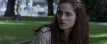 Movie still from “Syriana” (2005), directed by Stephen Gaghan – A person sitting on the ground; Close Up shot, Over the shoulder angle
