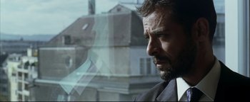 Movie still from “Syriana” (2005), directed by Stephen Gaghan – A person looking out of a window; Close Up shot, Over the shoulder angle