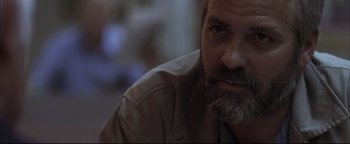 Movie still from “Syriana” (2005), directed by Stephen Gaghan – A person with a beard; Close Up shot, Over the shoulder angle