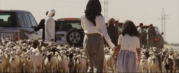 Movie still from “Syriana” (2005), directed by Stephen Gaghan – A group of people herding goats in a field; Wide shot, Low angle