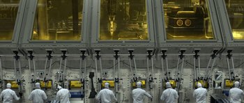 Movie still from “THX 1138” (1971), directed by George Lucas – A group of people in white lab coats are in front of a large window; Extreme Wide shot, High angle