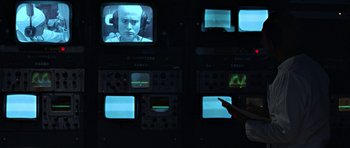 Movie still from “THX 1138” (1971), directed by George Lucas – A man on a tv screen; Close Up shot, Over the shoulder angle