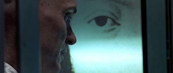 Movie still from “THX 1138” (1971), directed by George Lucas – A man's face is reflected in a mirror; Extreme Close Up shot, Over the shoulder angle