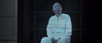 Movie still from “THX 1138” (1971), directed by George Lucas – A man sitting in front of a television screen; Medium shot, Low angle