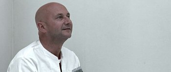 Movie still from “THX 1138” (1971), directed by George Lucas – A man in a white shirt is looking up; Close Up shot, Low angle