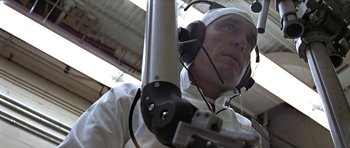Movie still from “THX 1138” (1971), directed by George Lucas – A man wearing a white shirt and a white hat; Close Up shot, Low angle