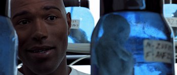 Movie still from “THX 1138” (1971), directed by George Lucas – A man's face on the side of a bus; Close Up shot, Overhead angle