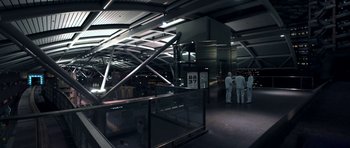 Movie still from “THX 1138” (1971), directed by George Lucas – A group of people standing in a room next to a building; Extreme Wide shot, High angle