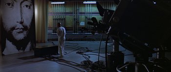 Movie still from “THX 1138” (1971), directed by George Lucas – A man standing in an empty room with wires hanging from the ceiling; Wide shot, High angle